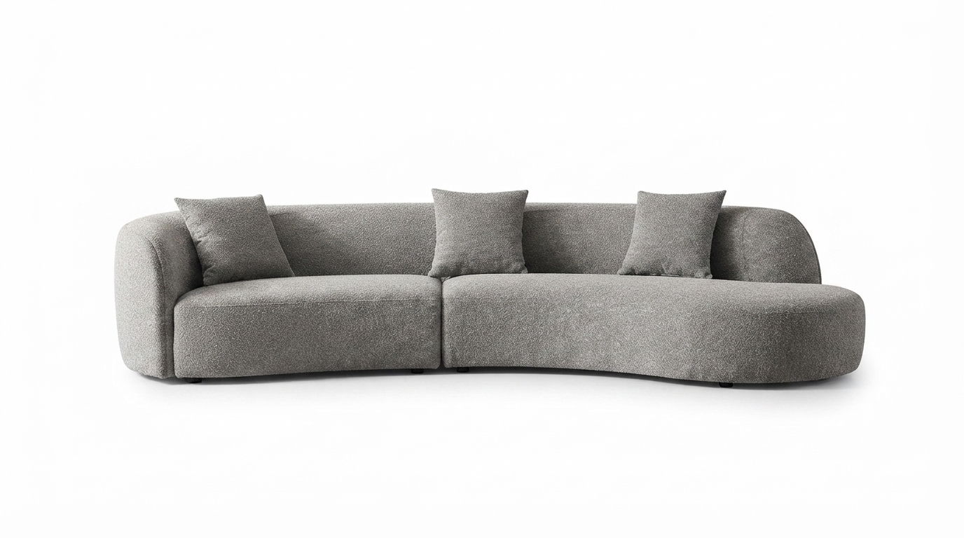 Curved_grey_sofa_with_pillows_202607271051 Curved Grey Sofa - Image 1